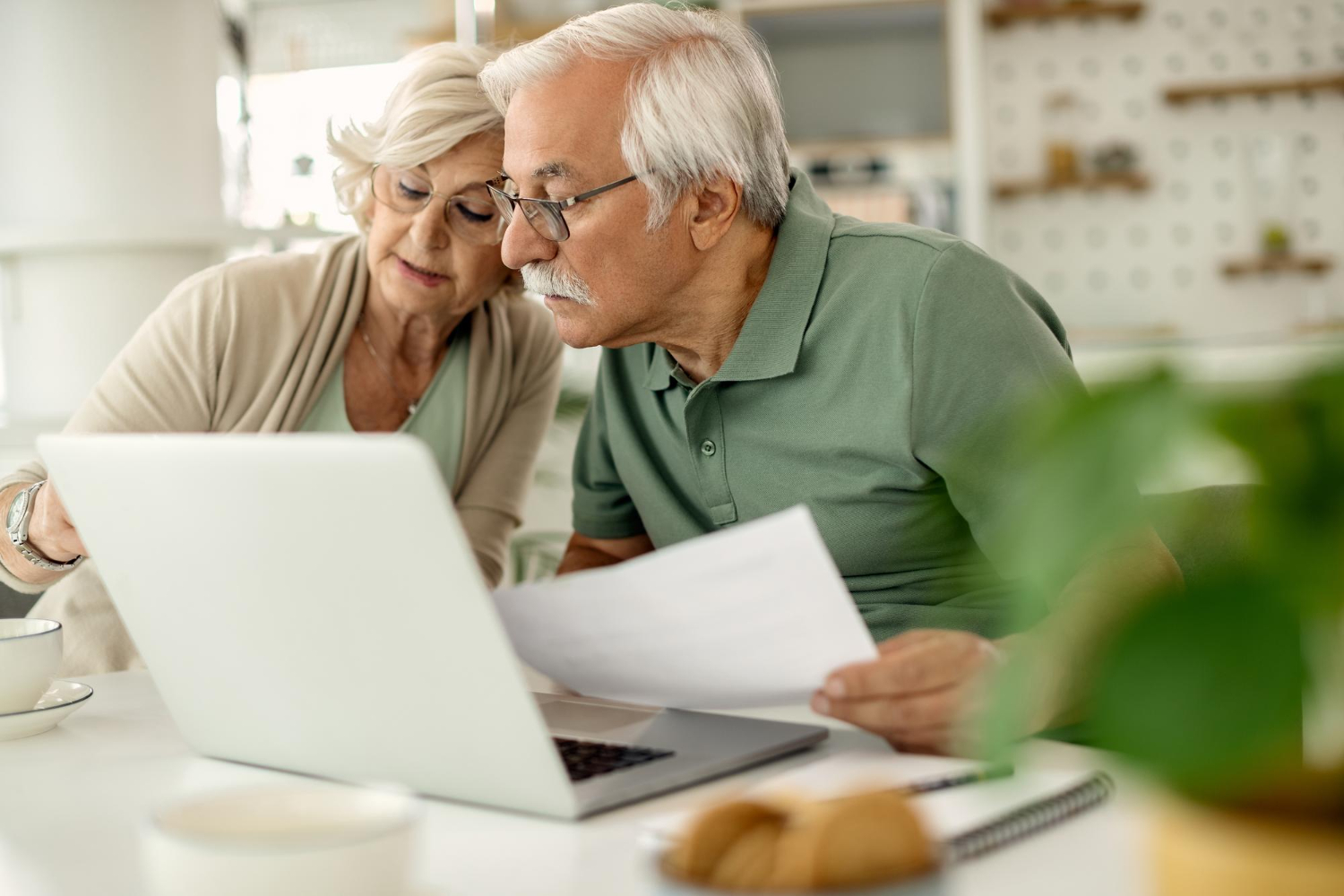 Elderly couple reviewing documents together